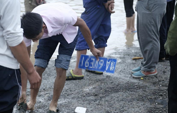 道路積水嚴重村民水中撈車牌賣錢-一個要價100元3